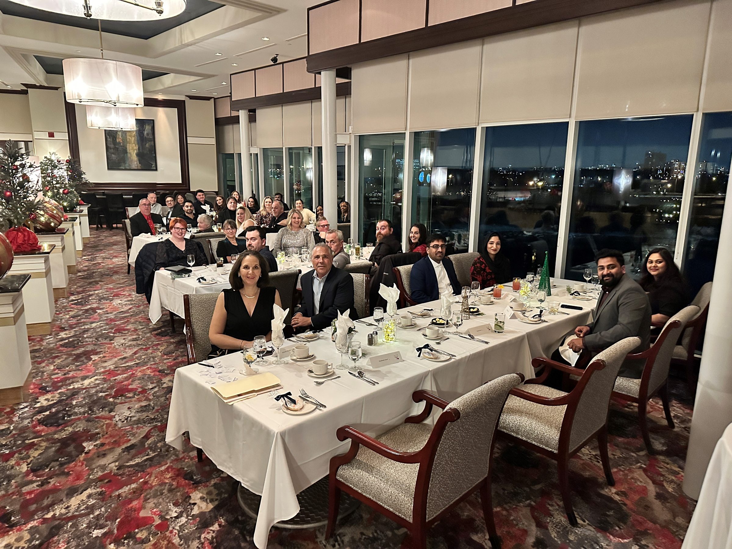 The D.E. Systems team gathered together at a company holiday dinner